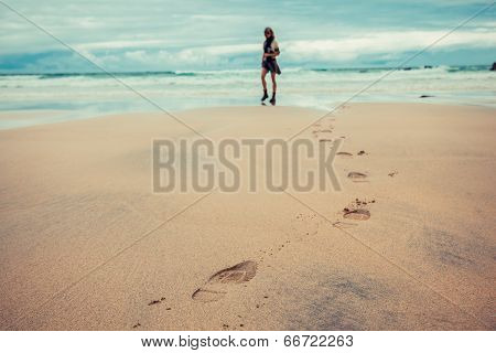 Footprints Left By Young Woman On Beach