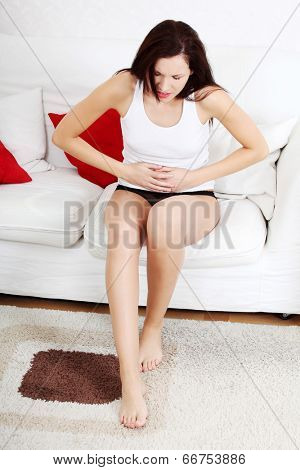 A photo of woman with stomach ache. Illness concepion.