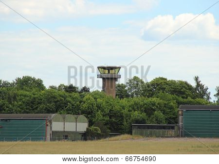 Airfield Control Tower Hidden In Forest With Clouds