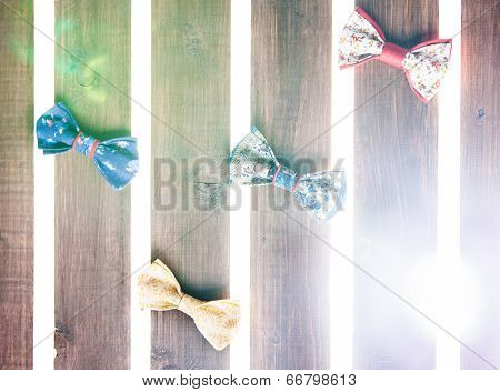 Set of handmade bow tie over wooden background