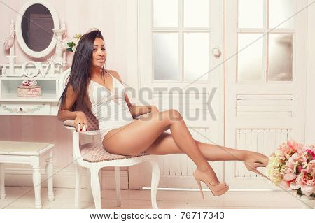 A sexy  woman lying on the bed in a pink room