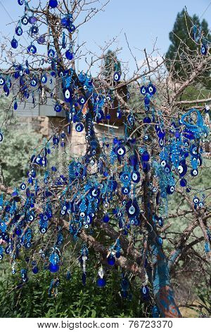 Evil eye in tree behind Uchisar Castle in Cappadocia