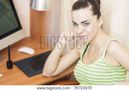 Portrait Of Positive And Smiling Caucasian Female At Home Near Computer With Pen Tablet