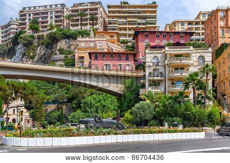 MONTE CARLO, MONACO - JULY 13, 2013: Colorful buildings and sculpture of William Grover-Williams in Bugatti racing car- the first winner of Monaco Grand Prix on April 14, 1929.