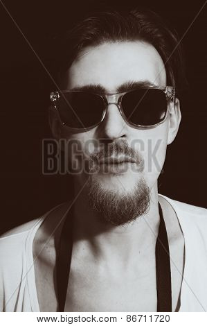 Portrait Of Young Man In Round Sunglasses