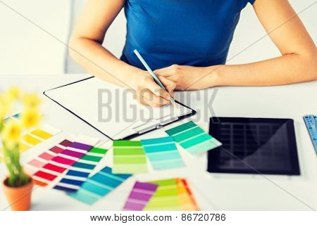 interior design, renovation and technology concept - woman working with color samples for selection