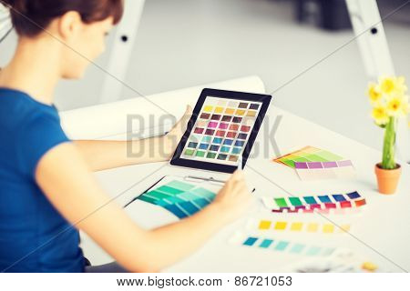 interior design, renovation and technology concept - woman working with color samples for selection