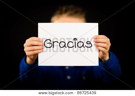 Child Holding Sign With Spanish Word Gracias - Thank You