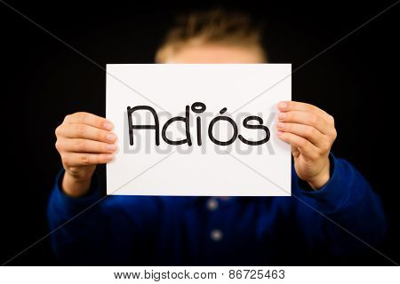 Child Holding Sign With Spanish Word Adios - Goodbye