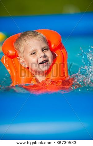 Pretty little boy in swimming pool