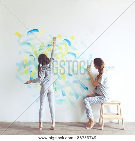 8 years old girl painting the wall at home, Instagram style toning