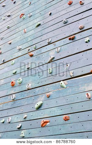 Grunge Surface Of An Artificial Rock Climbing Wall With Toe And Hand Hold Studs.