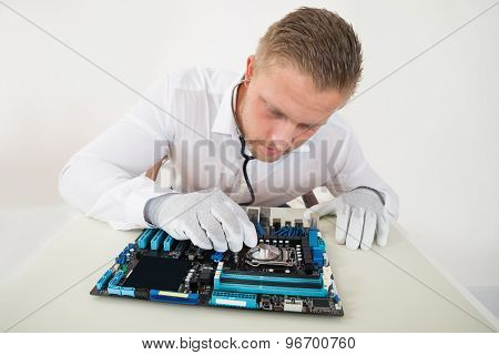 Technician With Motherboard And Stethoscope