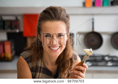 Closeup Of Smiling Woman Holding Camembert Slice On Cheese Fork