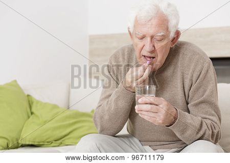 Ill Man Taking Medicine