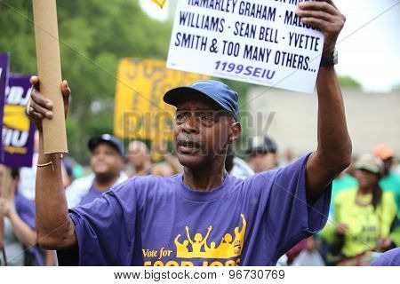 Activists with signs in Cadman Plaza