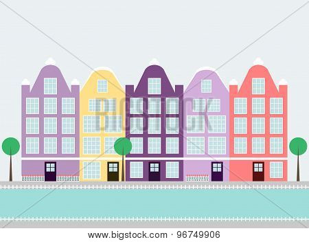 Cute colorful amsterdam houses on the water canal with trees.