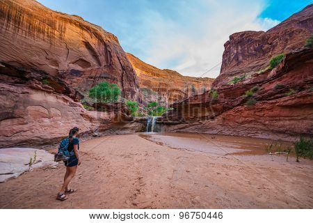 Girl Hiker Walking Towards The Waterfall Coyote Gulch Escalante