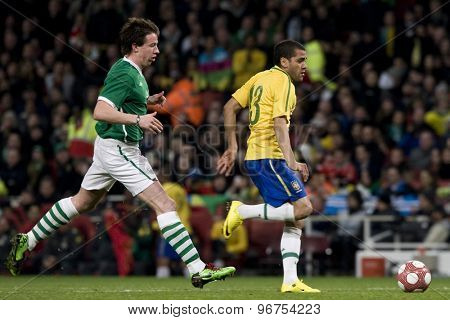 LONDON, ENGLAND. March 02 2010: Ireland's Sean St Ledger and Brazil's Daniel Alves during the international football friendly between Brazil and the Republic of Ireland played at the Emirates Stadium.