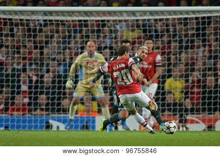LONDON, ENGLAND - Oct 01 2013: Arsenal's midfielder Mathieu Flamini from France takes a shot at goal during the UEFA Champions League match between Arsenal and Napoli.