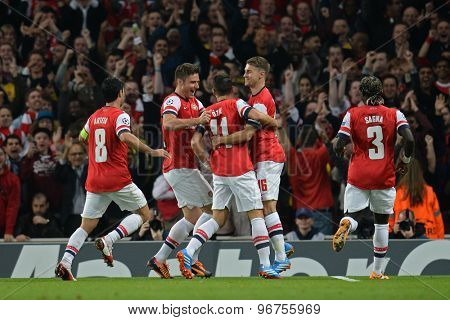 LONDON, ENGLAND - Oct 01 2013: Arsenal's midfielder Mesut Ozil from Germany  celebrates scoring a goal during the UEFA Champions League match between Arsenal and Napoli.