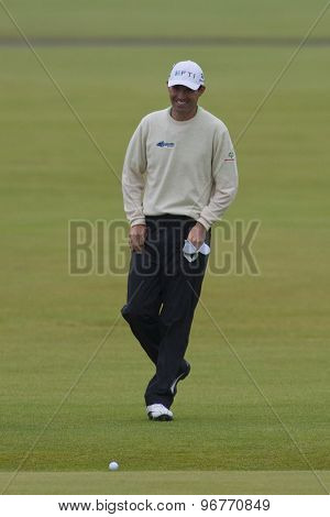 ST ANDREWS, SCOTLAND. July 15 2010: Padraig HARRINGTON from the Republic of Ireland laughing after he jumps across the burn on the first hole during the first day of The Open Championship