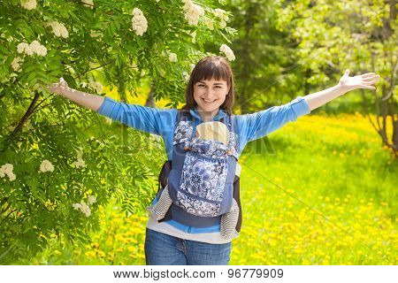 Newborn Baby And Mother Outdoors Walking With Sling.