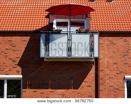 Red Sunshade Parasol On A Modern Balcony