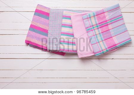 Pink  Kitchen Towels  On White Wooden Background.