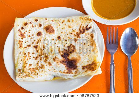 Roti Prata or Roti Canai, a traditional Indian bread served with curry