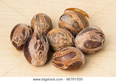 Close up and selective focus on a dried Nut Meg at foreground