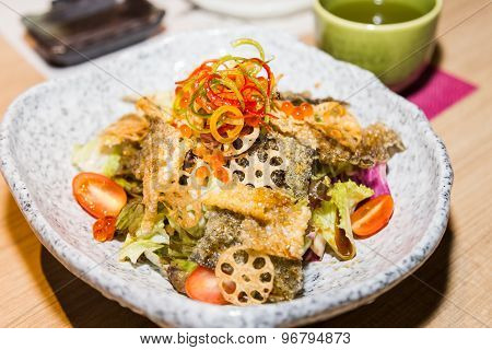 Japanese shake kawa salad with dried salmon skin and lotus roots