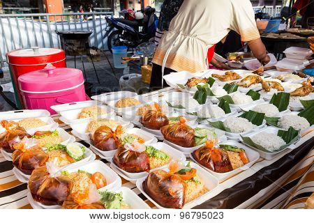 Vendor selling cuisine at street bazaar in Malaysia catered for iftar during Muslim fasting month of