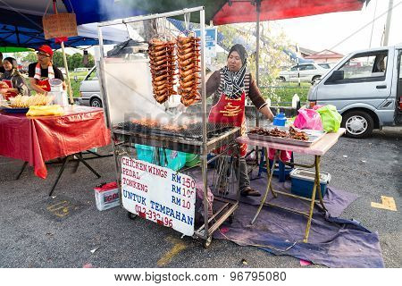 KUALA LUMPUR, MALAYSIA, JUNE 25, 2015: Vendors selling cuisine at street bazaar catered for iftar or breaking fast during the Muslim fasting month of Ramadan. Fasting for 2016 scheduled to fall on June 6.