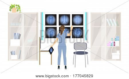 X ray cabinet in the clininc. Doctor examines the scans.