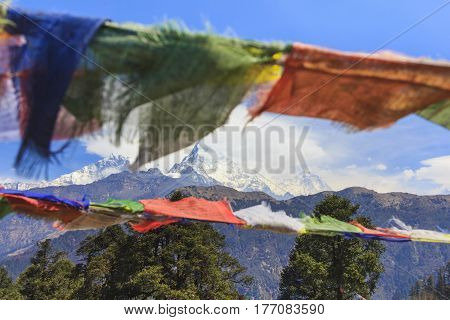 Nepal prayer flags and Annapurna mountain range view in background.