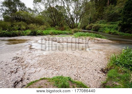 Mountain River In Summer Surrounded By Forest