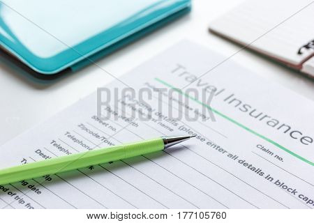 booking travel concept with insurance form on white table background