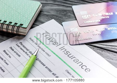 booking travel concept with insurance form and credit cards on gray wooden table background