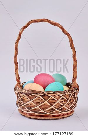 Basket with colored eggs isolated. Easter basket on white background. Get ready for Easter.