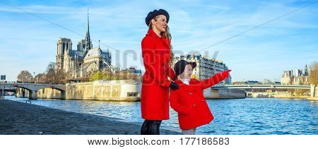 Mother And Daughter Travellers In Paris Pointing At Something