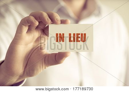 Businessman Holding In Lieu Message Card