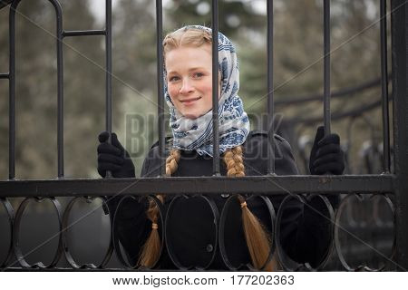 Beautiful Red-haired Girl Behind Forged Fence