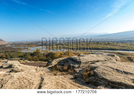View of Georgia from the hill in Uplistsikhe town, distant river and the forestgrounds.