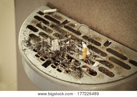 Trash bin with cigarettes butts, outdoor