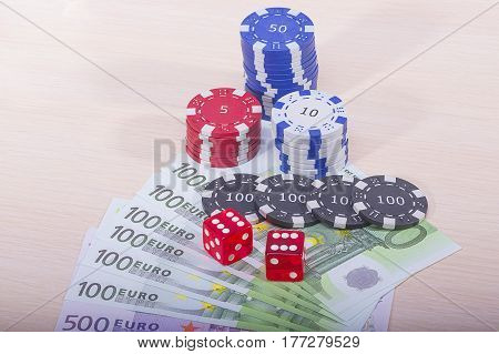 Multi-colored casino chips and money won on the game of gambling