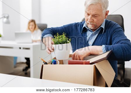 Challenge of my life . Involved unnerved aged office manager sitting in the office and gathering his belongings while holding the box and expressing despair