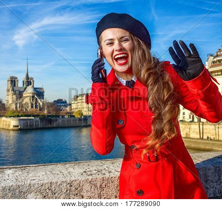 Woman On Embankment In Paris Talking On Cellphone And Handwaving