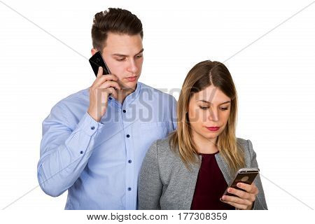 Picture of a young attractive couple being on their phones on isolated background