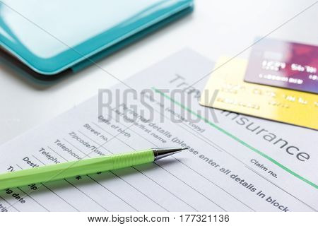 booking travel concept with insurance form and credit cards on white table background